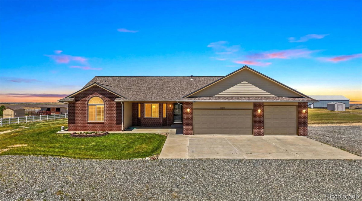 Front exterior of a two-story home with siding and brick accents