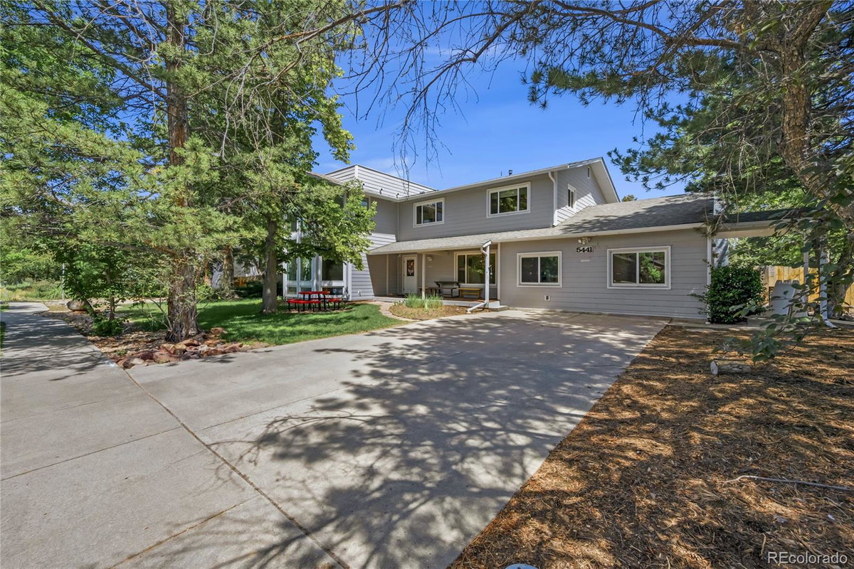 Front exterior of a two-story home with siding and brick accents