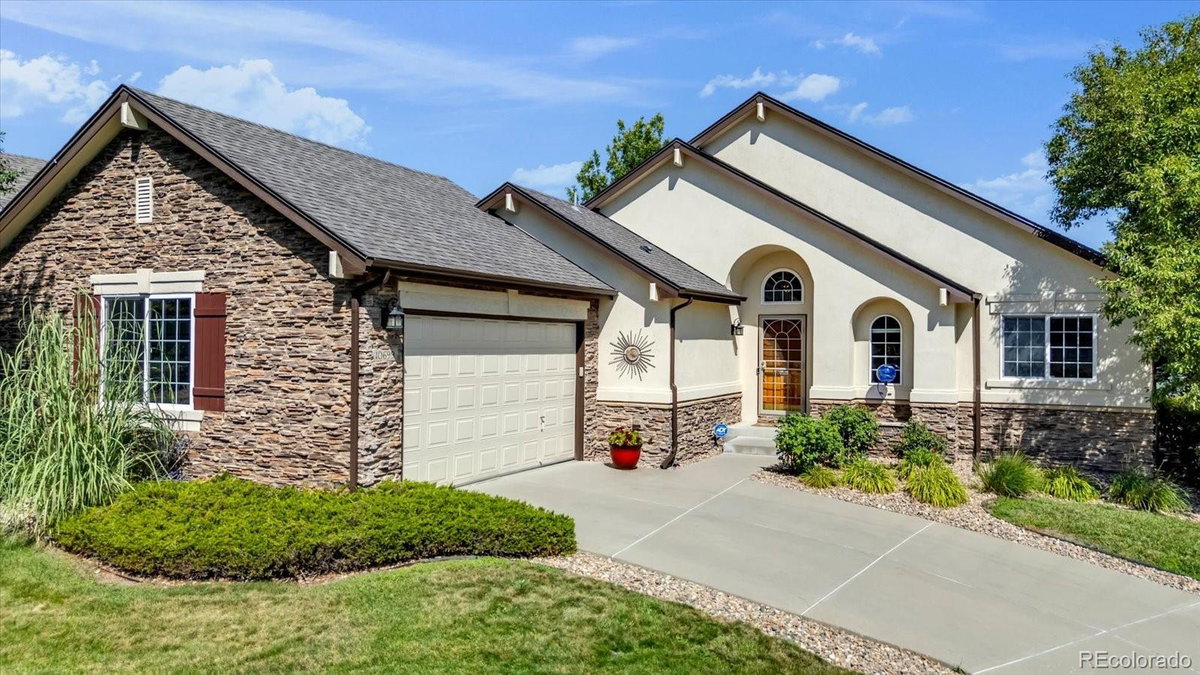 Front exterior of a two-story home with siding and brick accents