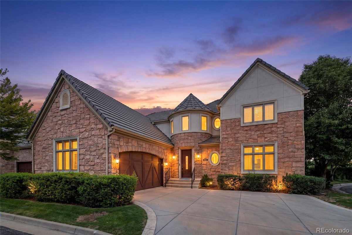 Front exterior of a two-story home with siding and brick accents
