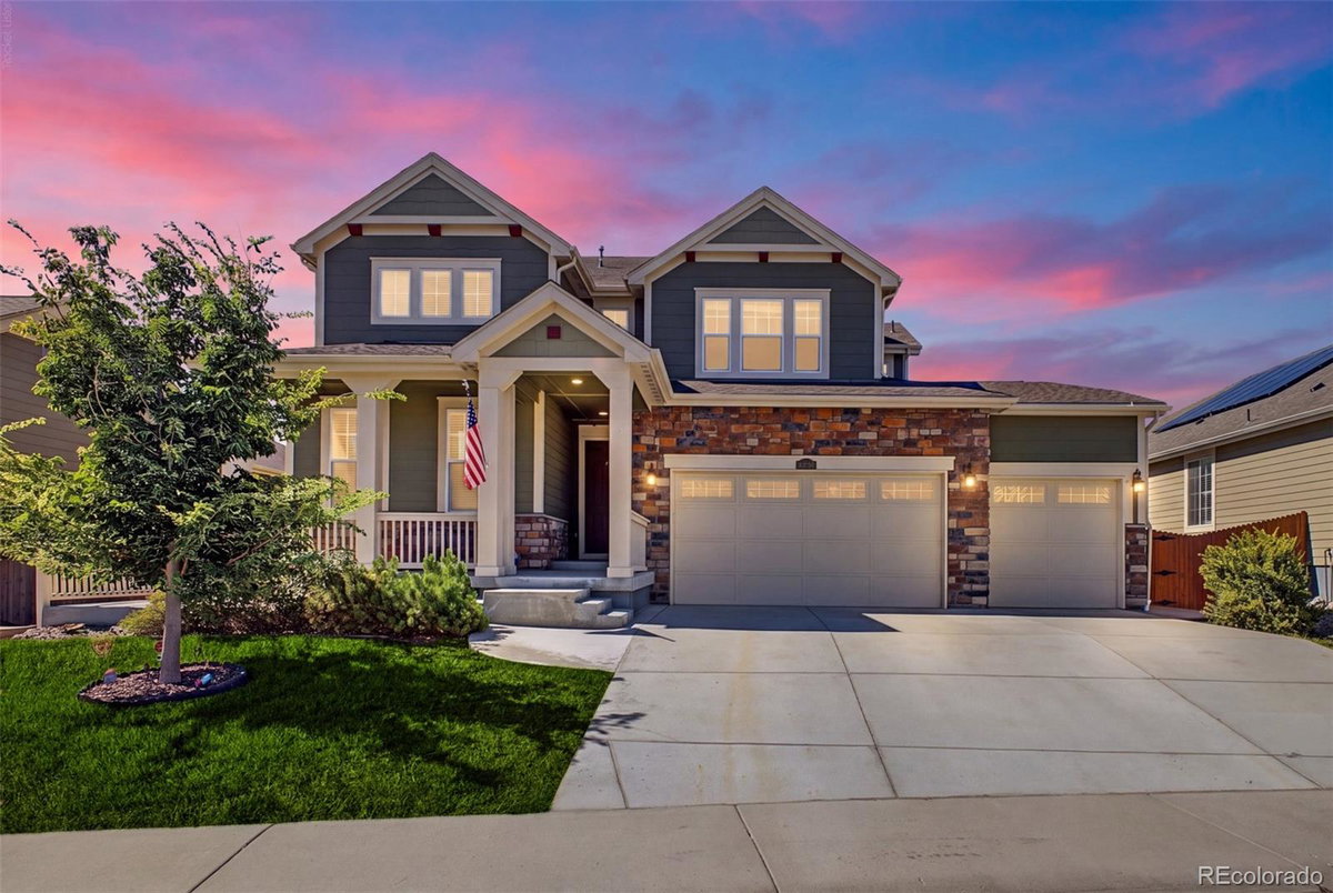 Front exterior of a two-story home with siding and brick accents