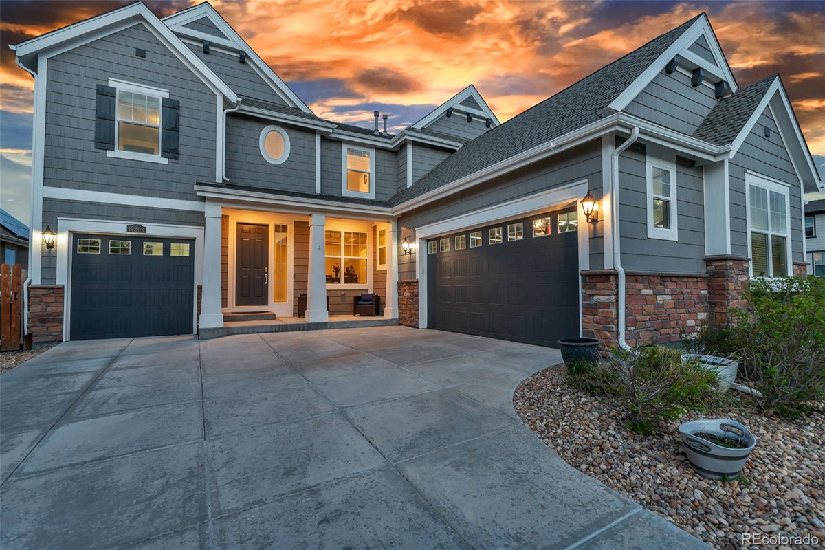 Front exterior of a two-story home with siding and brick accents