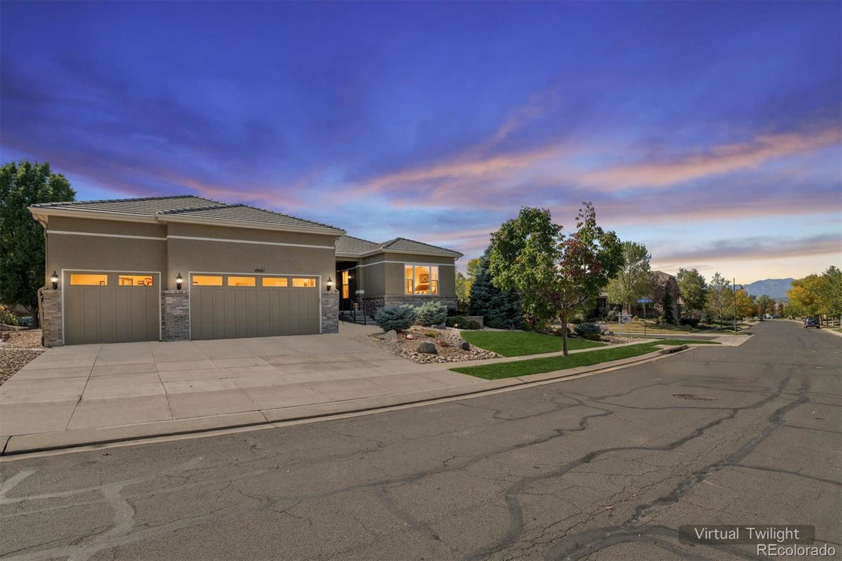 Front exterior of a two-story home with siding and brick accents