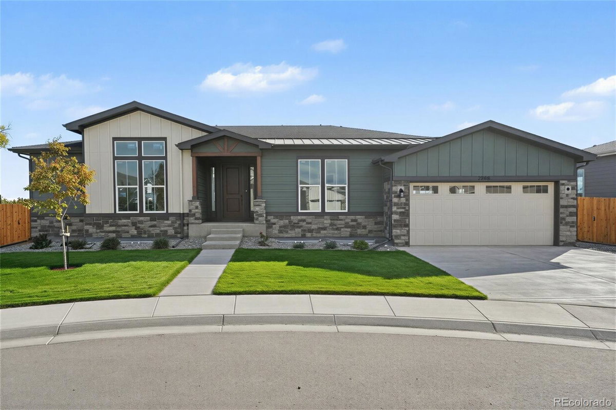 Front exterior of a two-story home with siding and brick accents
